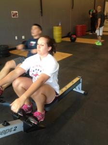 A 500m row before a series of 30 wall balls. Anna in the front, husband Kevin behind. (Photo by Jessica Schroeder, CrossFit Sandstorm Coach)